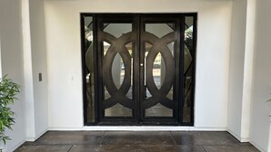 A modern entrance with a black door featuring a geometric design. - Luxury home with pickleball, pool, and hot tub near Scottsdale (Mesa)