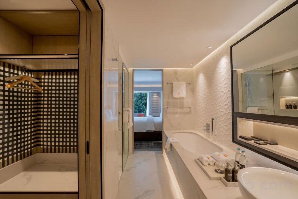 Bathroom | Deep soaking tub, rainfall showerhead, designer toiletries, hair dryer