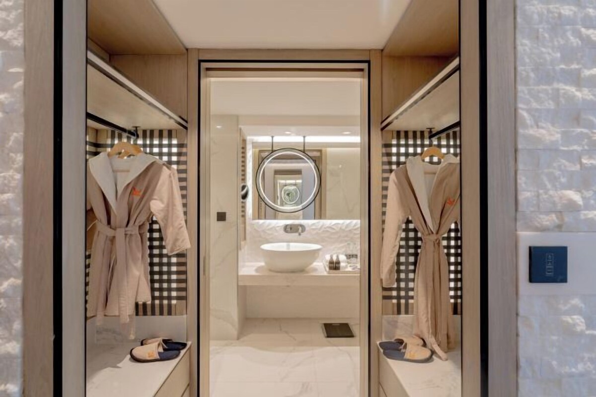 Deep soaking tub, rainfall showerhead, designer toiletries, hair dryer