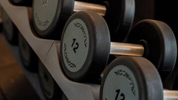 A rack of dumbbells with visible weight markings.