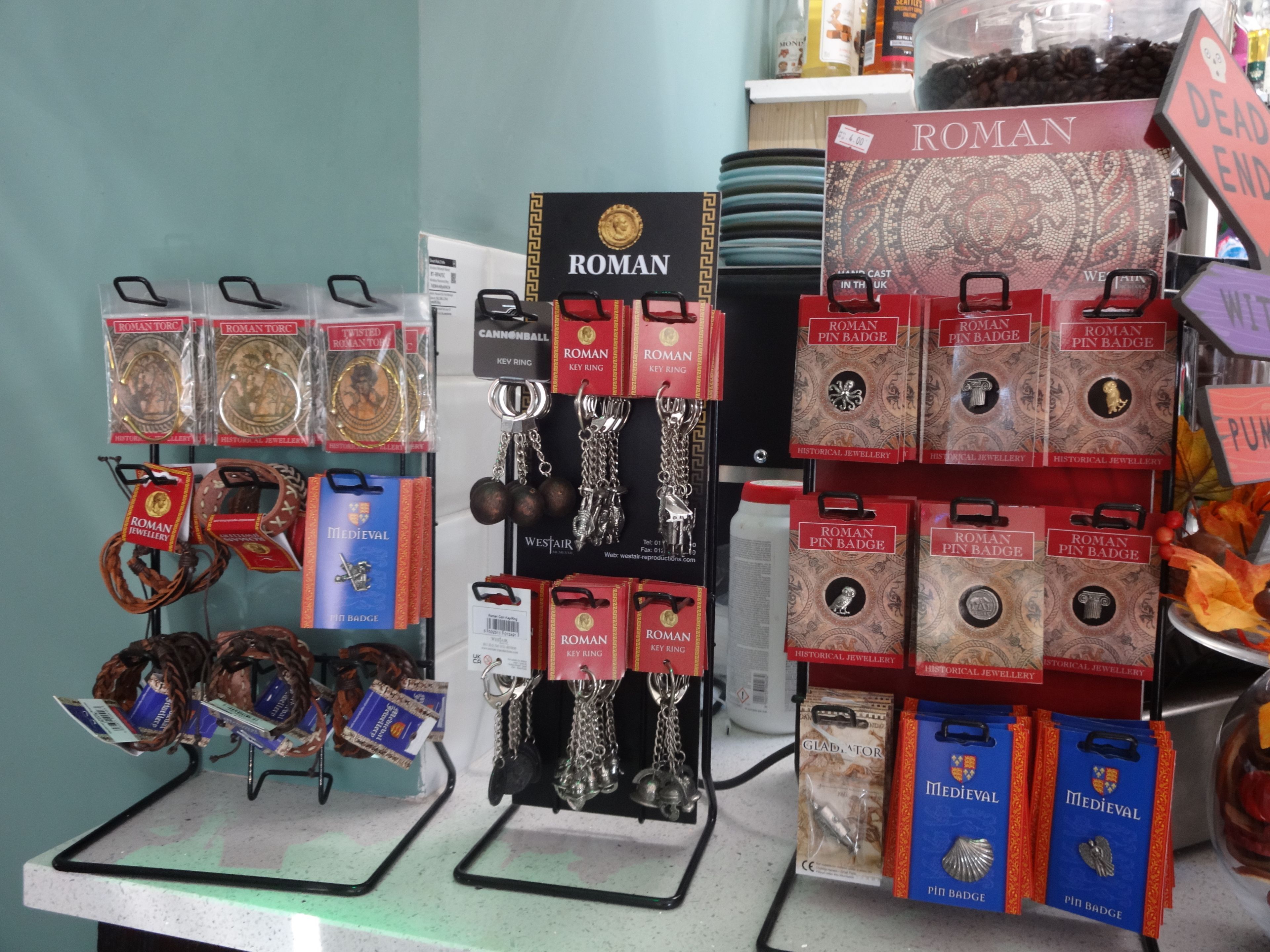 A display of Roman jewelry including key rings, badges, and pendants.