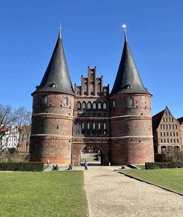 A historic building with two prominent towers and a central archway.