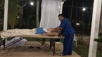 Relax and unwind in our serene outdoor massage area, featuring a massage table and soothing surroundings.