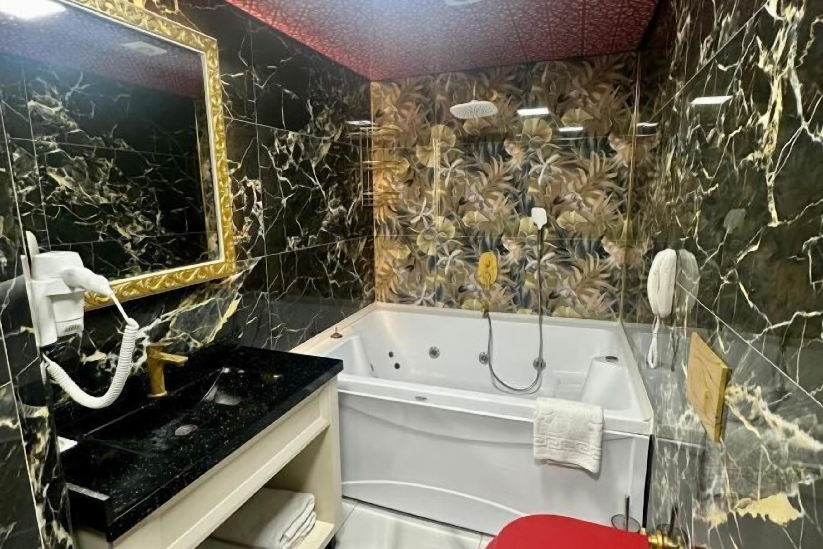 Bathroom | Rainfall showerhead, hair dryer, bathrobes, slippers