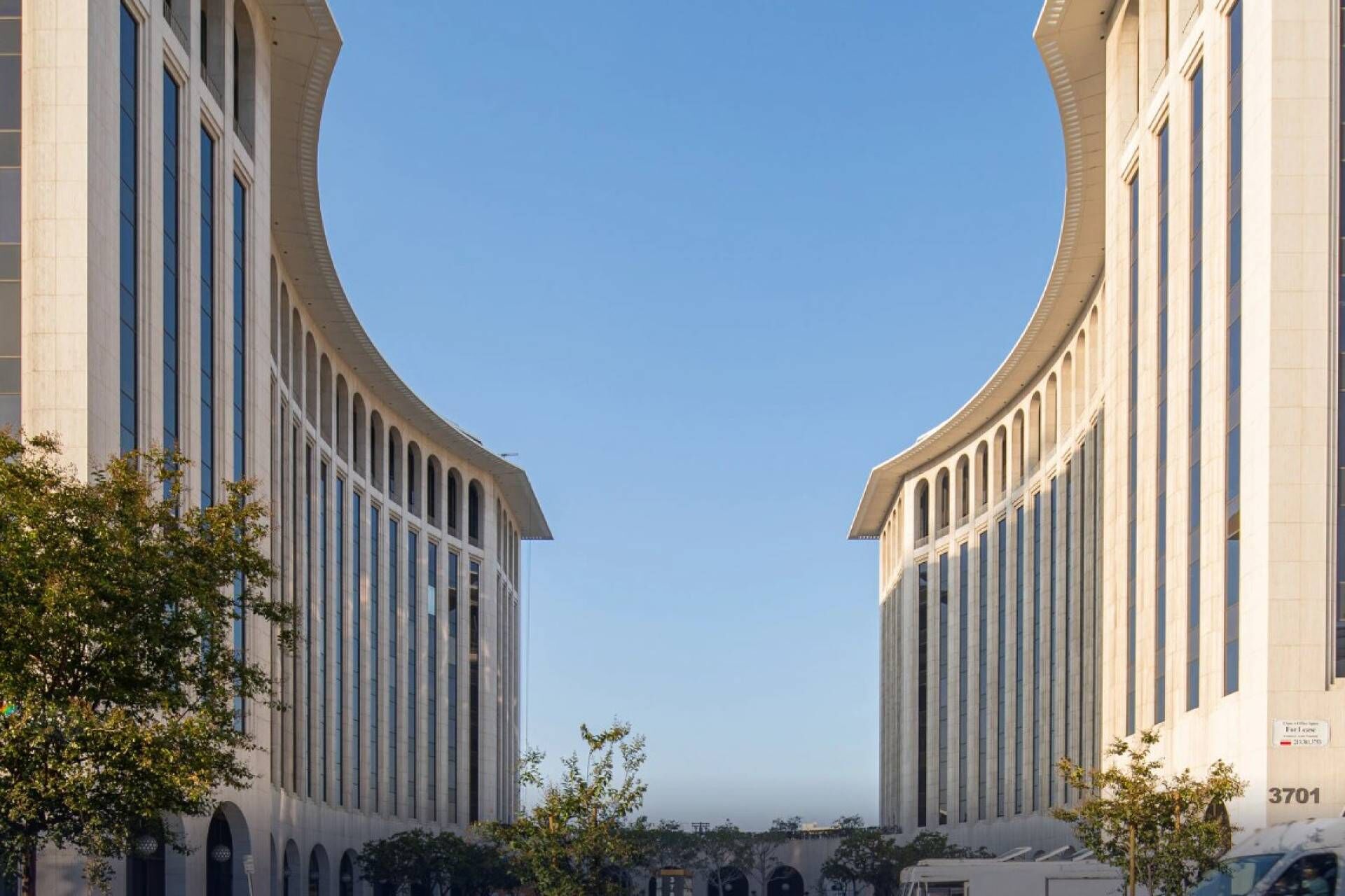 A symmetrical building with a curved facade and multiple windows.