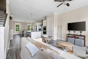 Relax in this stylish living area with a comfortable sofa, flat-screen TV, and wooden coffee table.