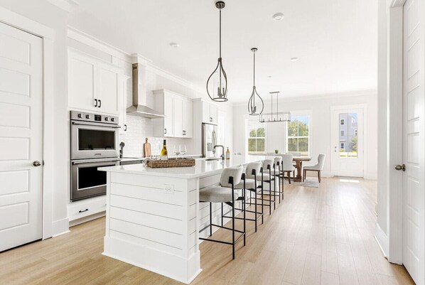 Fridge, coffee/tea maker, cookware/dishes/utensils, dining tables