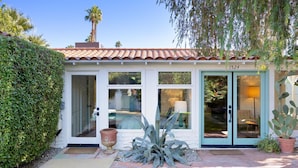 A house with a tiled roof, large windows, and a number 1524 on the door. - Dog-Friendly Bungalow with Private Pool (Palm Springs)