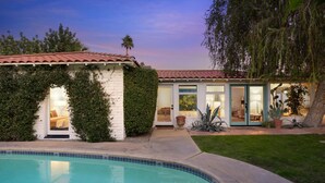 A two-story house with a swimming pool, a patio, and a well-maintained garden. - Dog-Friendly Bungalow with Private Pool (Palm Springs)