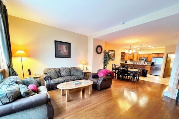 Open Plan Living Area with natural gas fireplace and queen pullout sofa bed.
