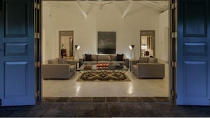 A spacious living room with a large sofa set, a coffee table, and two side tables. - Dutch Colonial Period Villa In Contemporary Style (Angulugaha)
