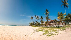 A beach with a house and palm trees. - Family Beach Villa Located On An Incredible Beach (Koggala)