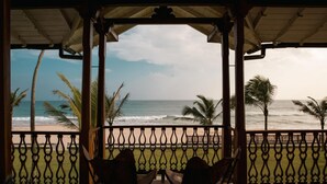 A covered outdoor seating area with a view of the beach and ocean. - Family Beach Villa Located On An Incredible Beach (Koggala)