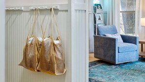 A room with a wooden floor, a blue armchair, and a woven bag hanging on the wall. - Folly - Large Front Porches - One Block to Beach (Folly Beach)