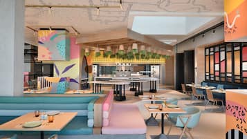A modern restaurant with booths, tables, and a bar area.