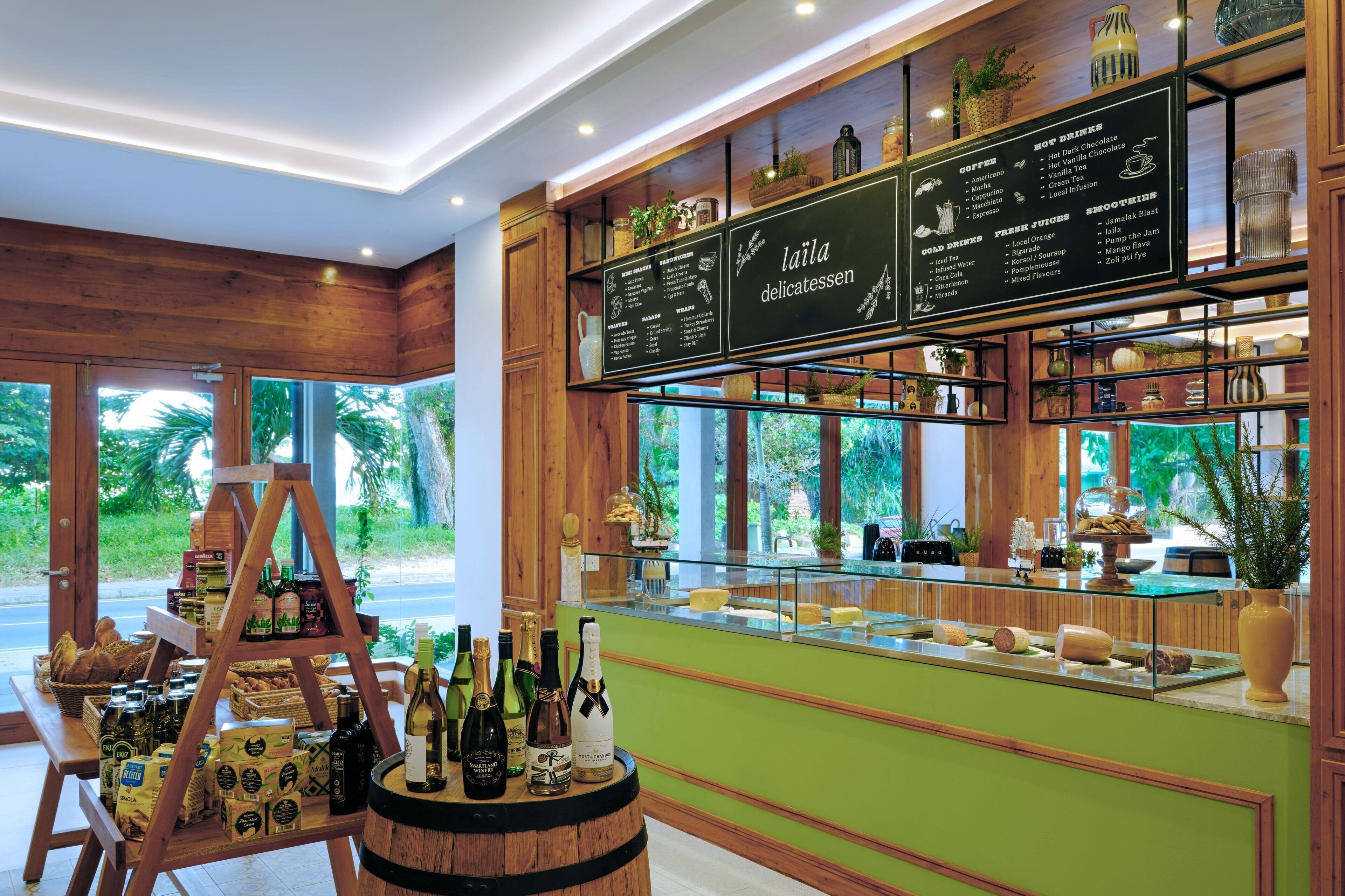 Una cafeteria amb interior de fusta, una pissarra amb el menú i una presentació de menjar i begudes.