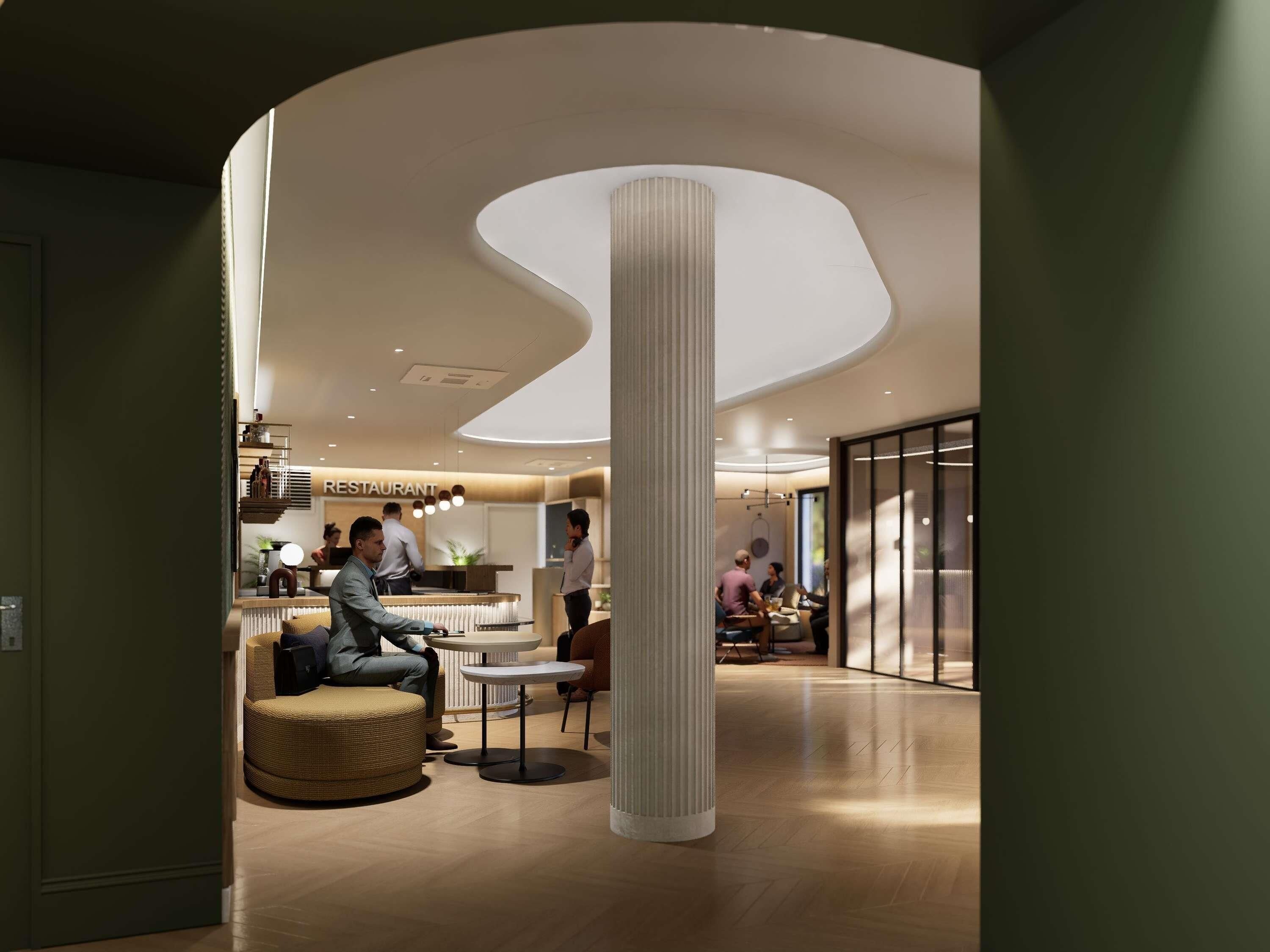 Un interior moderno con una columna central, zonas de estar y un restaurante al fondo.