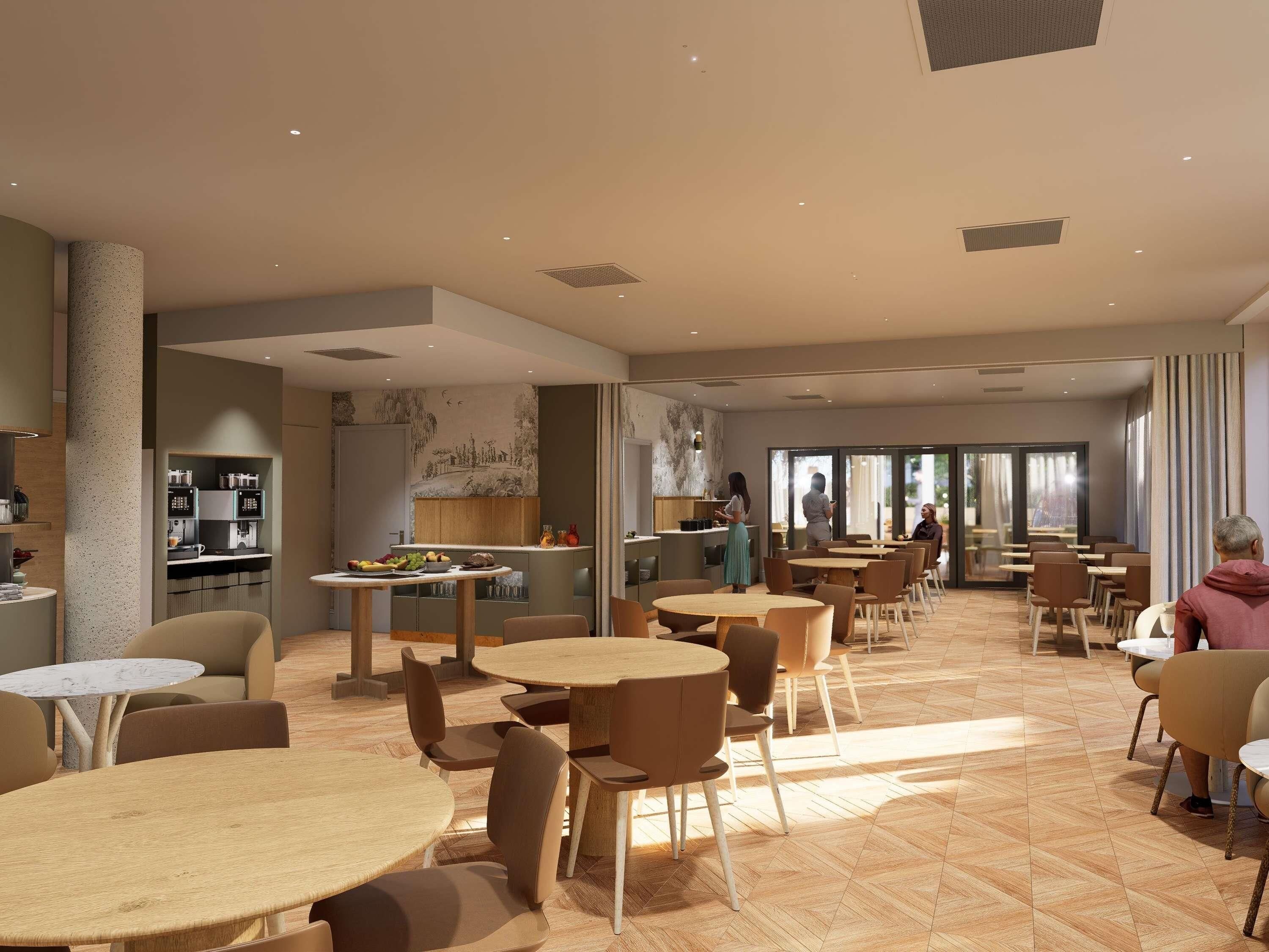 Un espace intérieur vaste et bien aménagé, avec plusieurs coins salon, une cuisine et de grandes fenêtres offrant une vue dégagée.