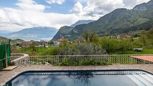 A swimming pool with a view of mountains and houses.