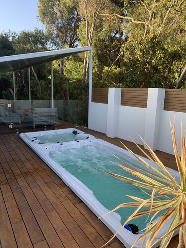 A nature haven within walking distance to beach/town with pool - swim spa- deck.