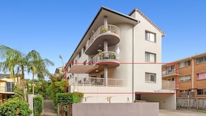 Stylish residential building with a flat roof and balconies.