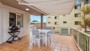 Enjoy al fresco dining on the balcony with a barbecue grill and seating for four.