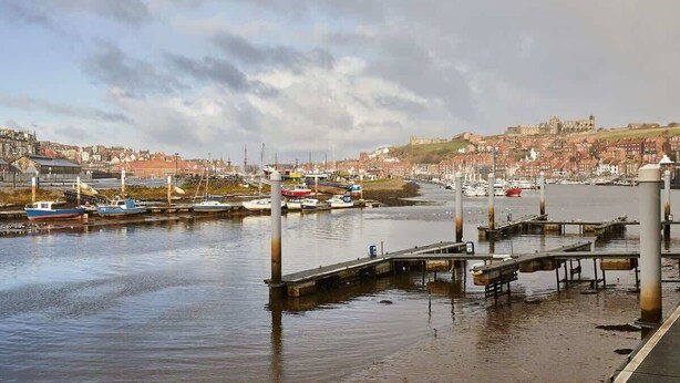 A harbor with boats docked, a pier, and buildings in the background. - Host & Stay | Harbour View (Whitby)