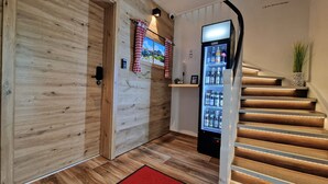 A wooden staircase with a built-in refrigerator at the bottom. - Comfortable, bright vacation apartment with balcony and alpine view in Pfronten Mitte (Pfronten)