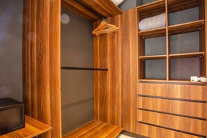 A wooden wardrobe with multiple shelves and hanging space.