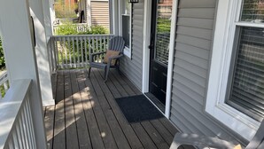 A wooden porch with a chair and a door. - Newly Updated: Nearby Short North / OSU! (Columbus)