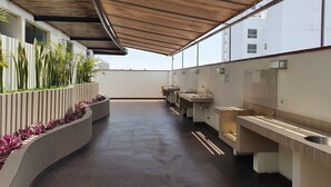 A modern outdoor restroom with multiple sinks and a covered walkway.