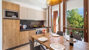 Una cocina moderna con microondas, armarios de madera y una zona de comedor lista para una comida.