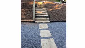 A set of stone steps leading up to a wooden structure, surrounded by a gravel path and a forested hillside. - Cute cabin😊Pretty Views! Clean! ONLY 1 MILE TO TOWN! (Hiawassee)