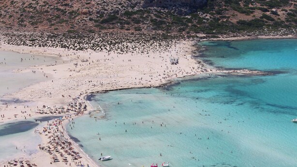 An aerial view of a beach with clear turquoise waters, sandy shores, and rocky terrain in the background. - Dioni - Vacation house with private pool in Kounoupidiana, Crete (Plakoúres)
