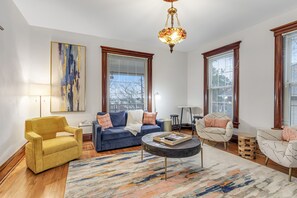 Relax in this stylish living room with a comfortable sofa set, armchair, and coffee table.