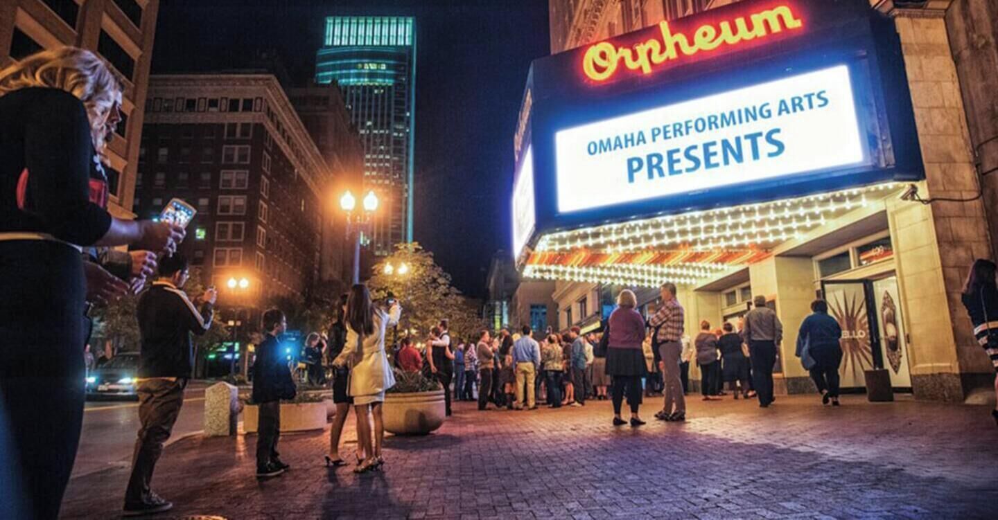A theater marquee with the word "Orpheum" and "Omaha Performing Arts Presents" indicating a performance.