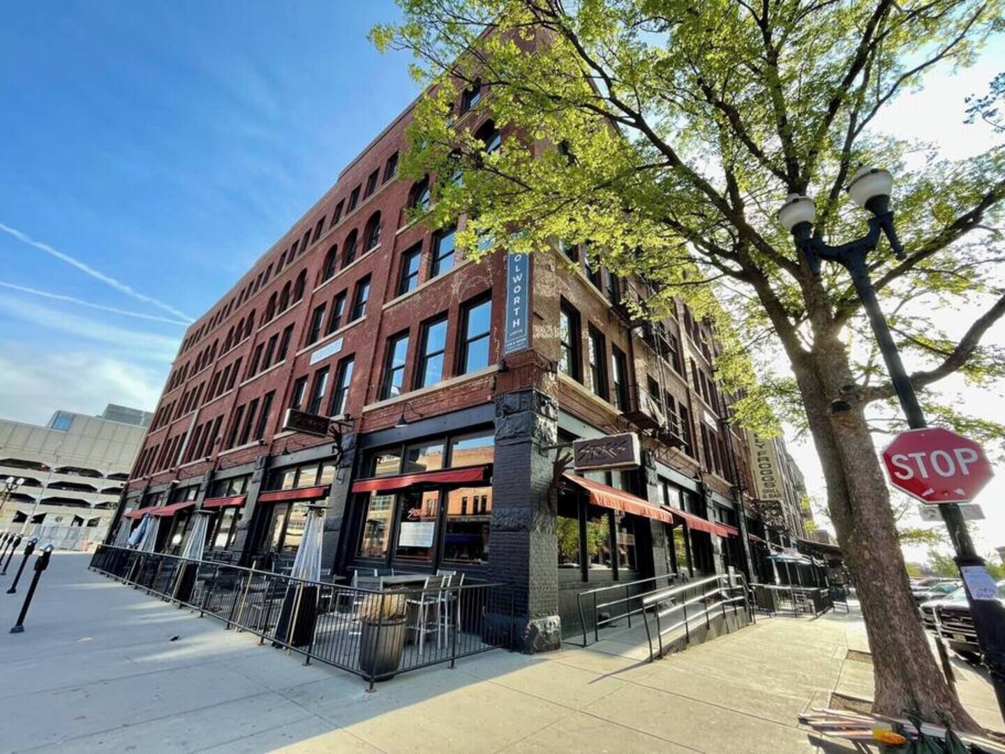 A multi-story brick building with a storefront on the ground floor.