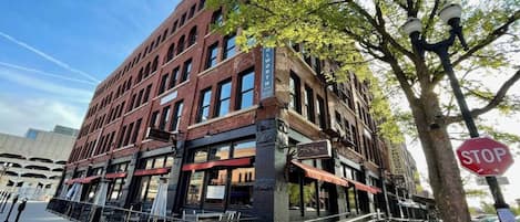 A multi-story brick building with a storefront on the ground floor.