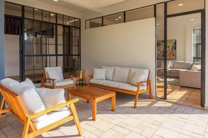 A spacious living area with a sofa, chairs, and a coffee table. - New, in the heart of the city, 5 min to US Embassy (Antiguo Cuscatlán)