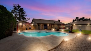 A residential property with a swimming pool, a covered patio, and a fenced backyard. - Amenities Galore! Outdoor Living & Lots of Games (Peoria)