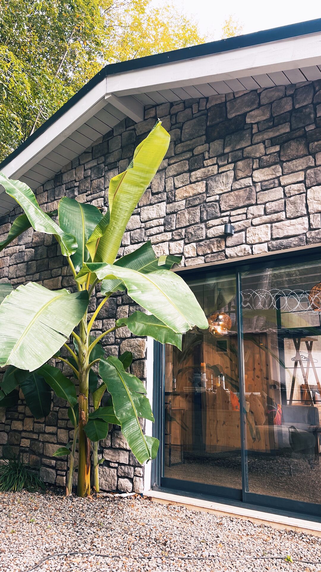 A building with a stone facade and a large glass window.