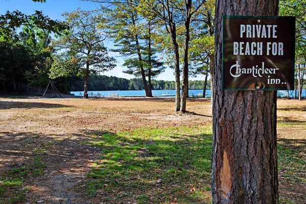 A sign indicating a private beach for Chanticleer Inn.