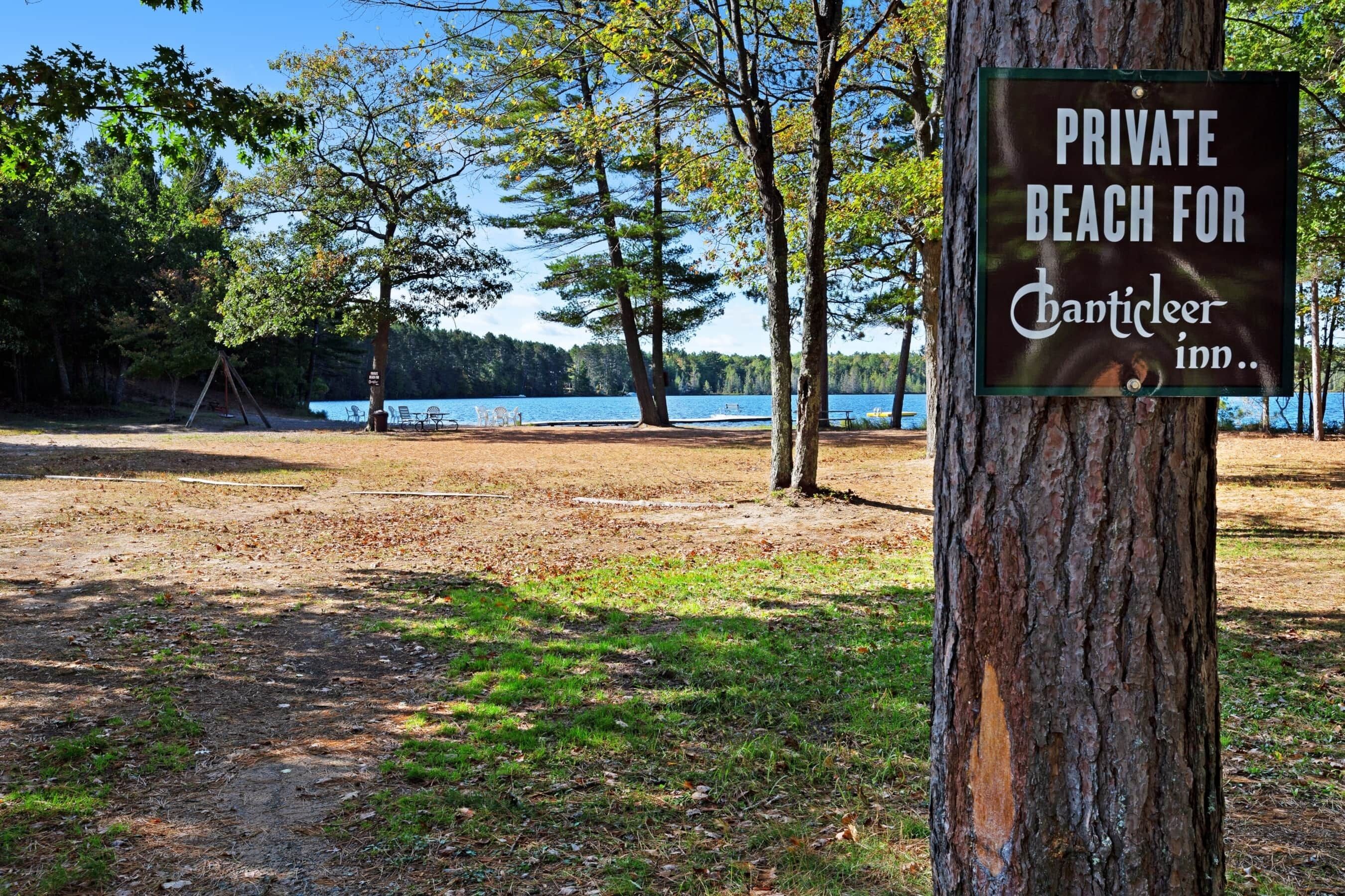 A sign indicating a private beach for Chanticleer Inn.