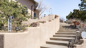 A concrete staircase leading to a beige building with a small window. - sweet little casita (Santa Fe)