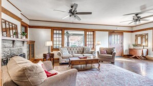 A spacious living room with a fireplace, two sofas, a coffee table, and a rug.