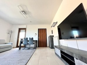 Premier Apartment | Living area | 55-inch Smart TV with digital channels, TV, streaming services