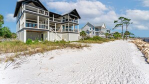 A beachfront property with a multi-level house featuring balconies and a sandy beach path. - New Windmark Phase 1 home on the beach with amazing views. (Port St. Joe)