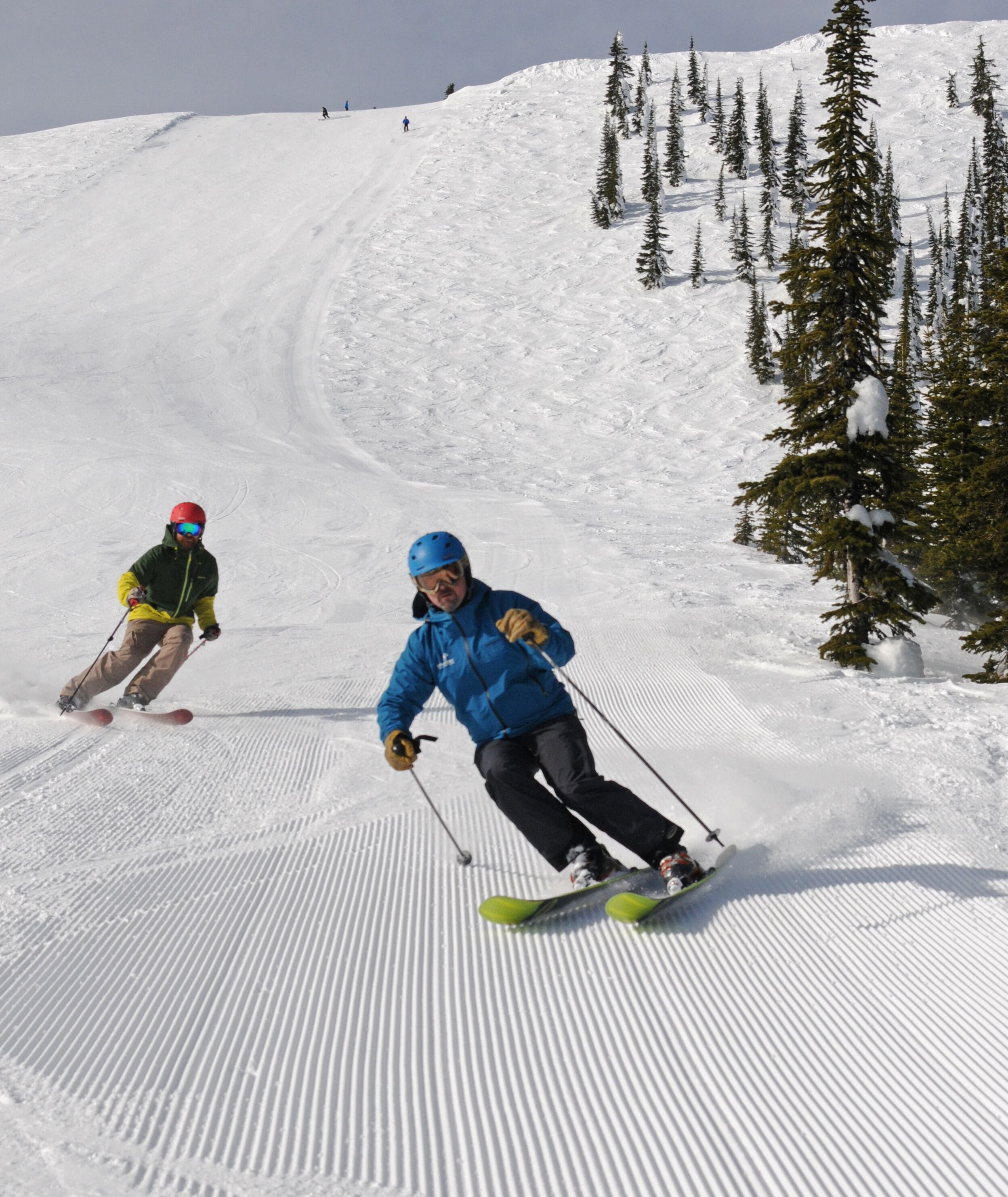 A snowy ski slope with skiers.