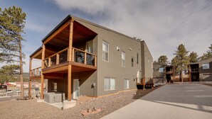 A two-story building with a balcony, a covered outdoor area, and a driveway. - Woodland Park Escape: Hot Tub & Mtn Views 331446 (Woodland Park)