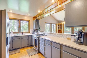 Enjoy cooking in this kitchen with a large island, stove, and ample counter space.